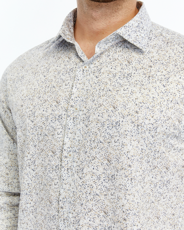 Close-up of a person wearing a textured grey based printed shirt