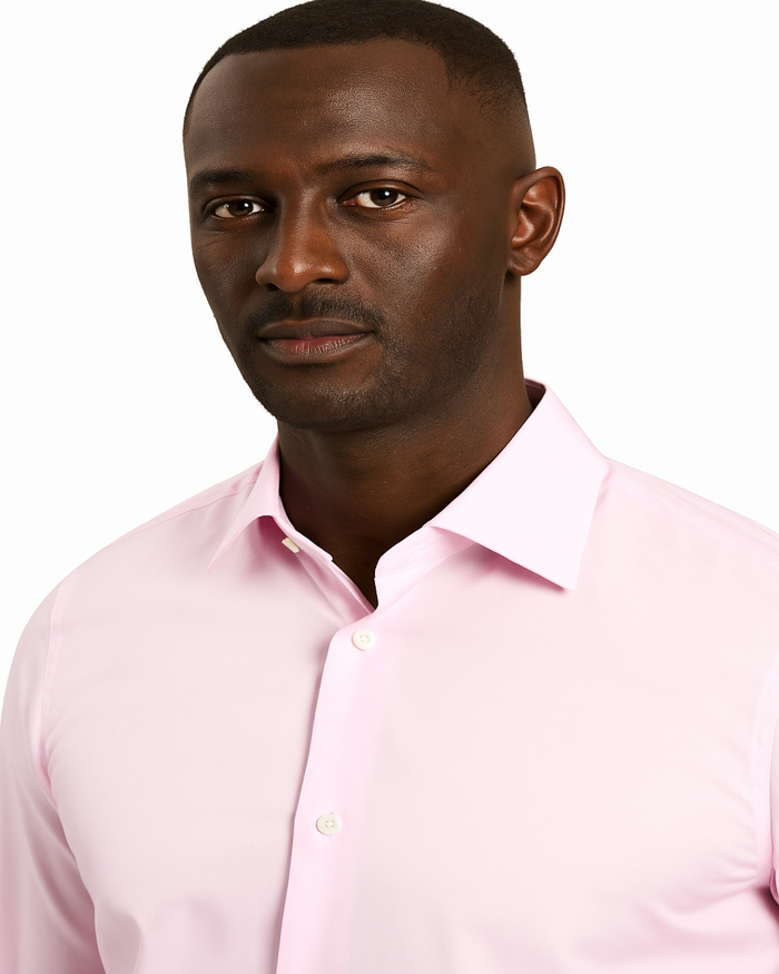 Man wearing a light pink dress shirt