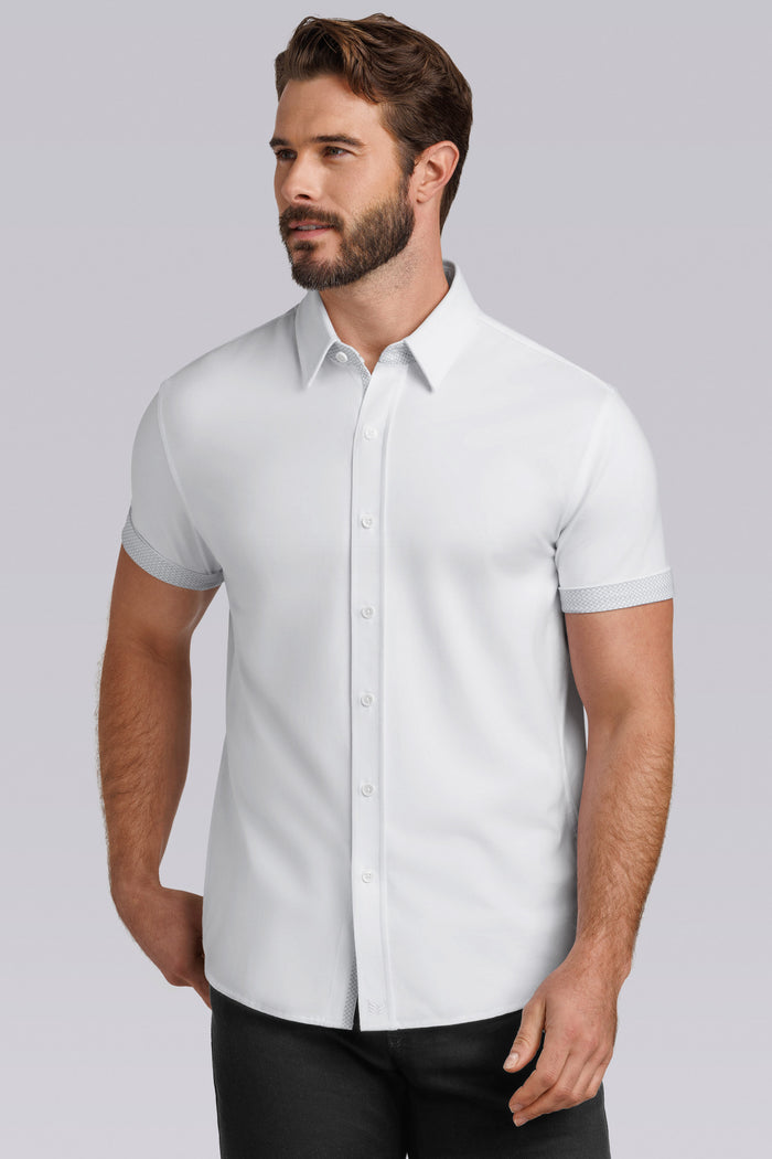 Model wearing Iconic Rapport White short sleeve classic collar shirt, styled with black pants