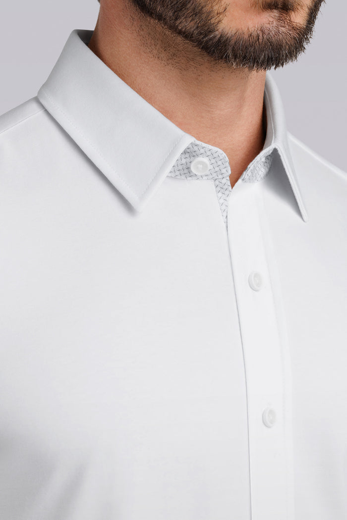 Model wearing Iconic Rapport White short sleeve classic collar shirt, styled with black pants