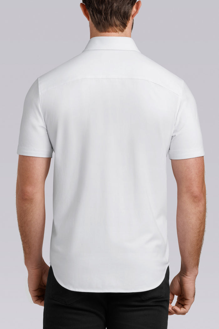 Model wearing Iconic Rapport White short sleeve classic collar shirt, styled with black pants