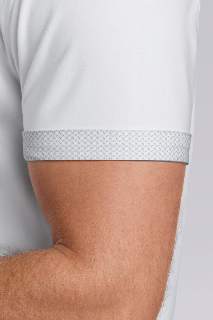 Model wearing Iconic Rapport White short sleeve classic collar shirt, styled with black pants