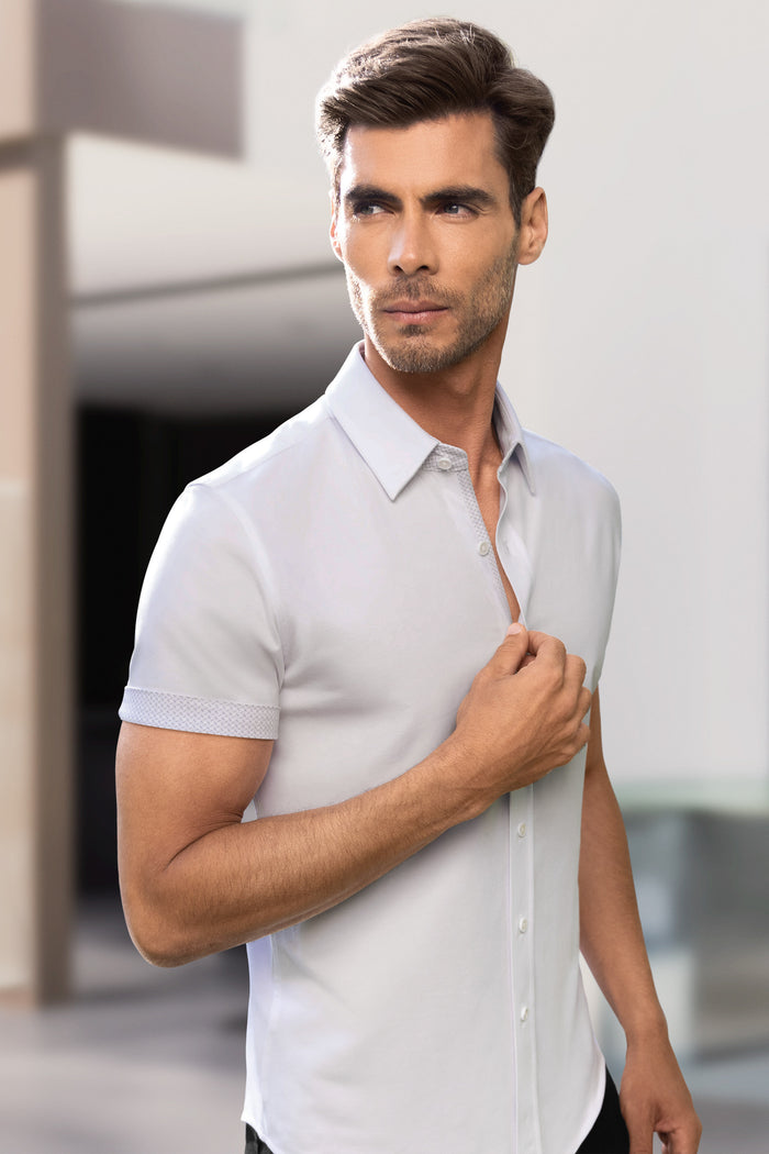 Model wearing Iconic Rapport White short sleeve classic collar shirt, styled with black pants