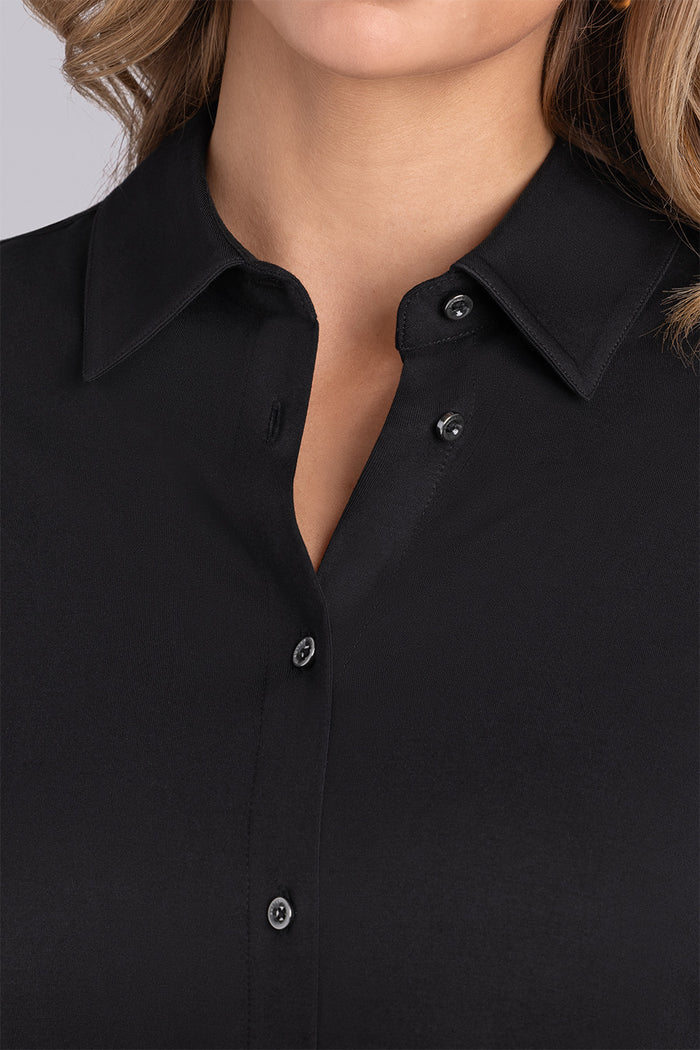Model wearing Idol Black Icy Bamboo® long sleeve classic collar shirt, styled with white pants.