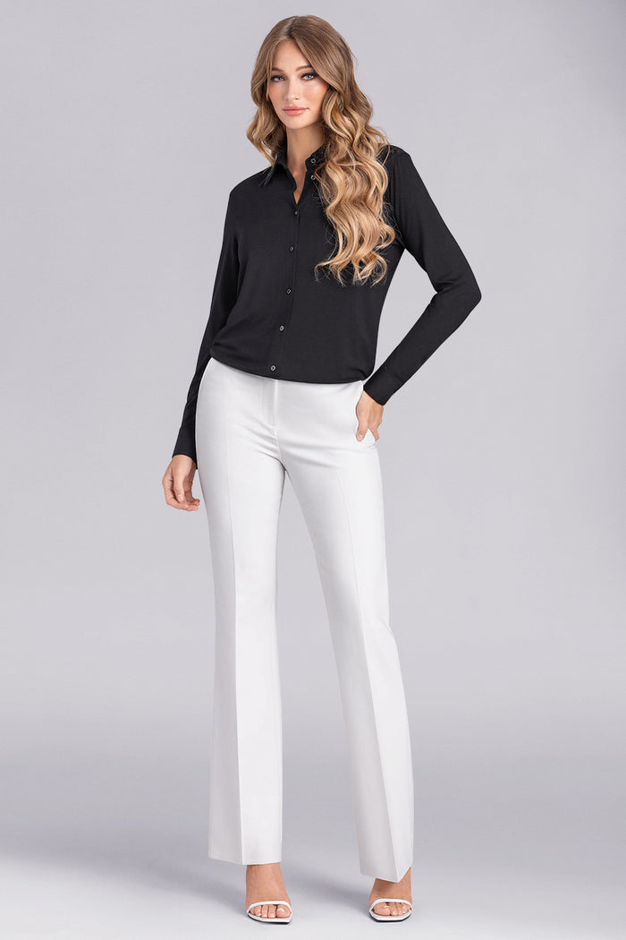 Model wearing Idol Black Icy Bamboo® long sleeve classic collar shirt, styled with white pants.