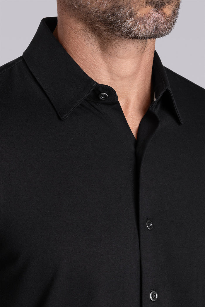 Model wearing Illustrious Black Icy Bamboo® long sleeve dress shirt, styled with black pants