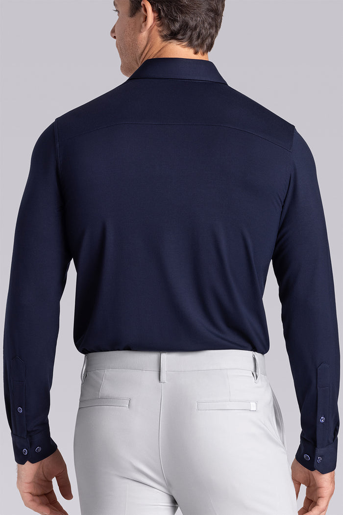 Model wearing Illustrious Monaco Blue Icy Bamboo® long sleeve dress shirt, styled with white pants