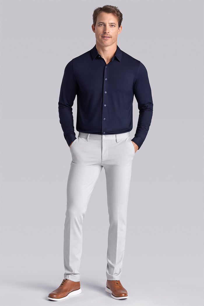 Model wearing Illustrious Monaco Blue Icy Bamboo® long sleeve dress shirt, styled with white pants
