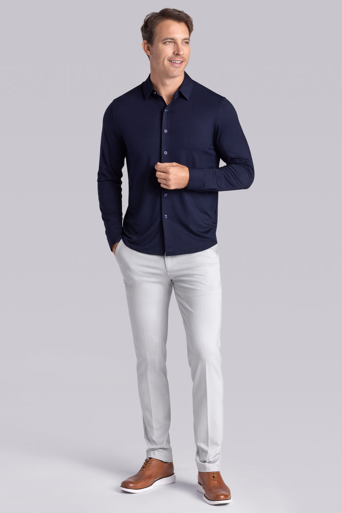 Model wearing Illustrious Monaco Blue Icy Bamboo® long sleeve dress shirt, styled with white pants