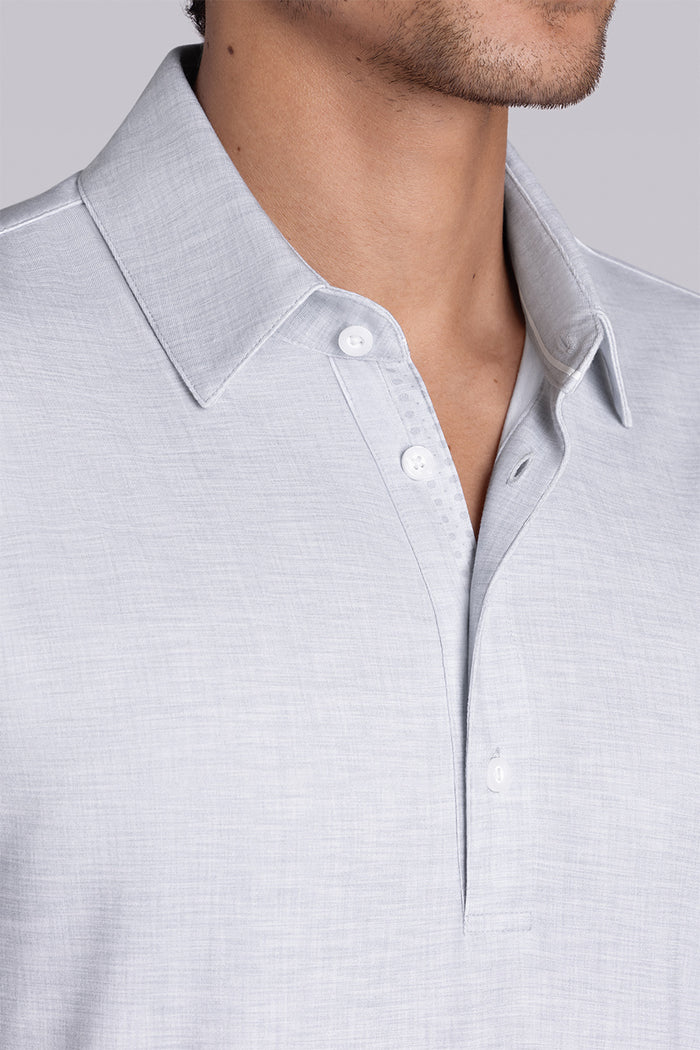 Model wearing Immaculate Light Grey short sleeve polo, styled with white pants