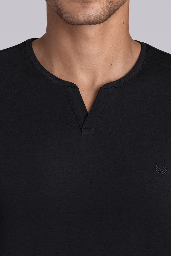 Model wear Infallible in Black short sleeve shirt, styled white shorts