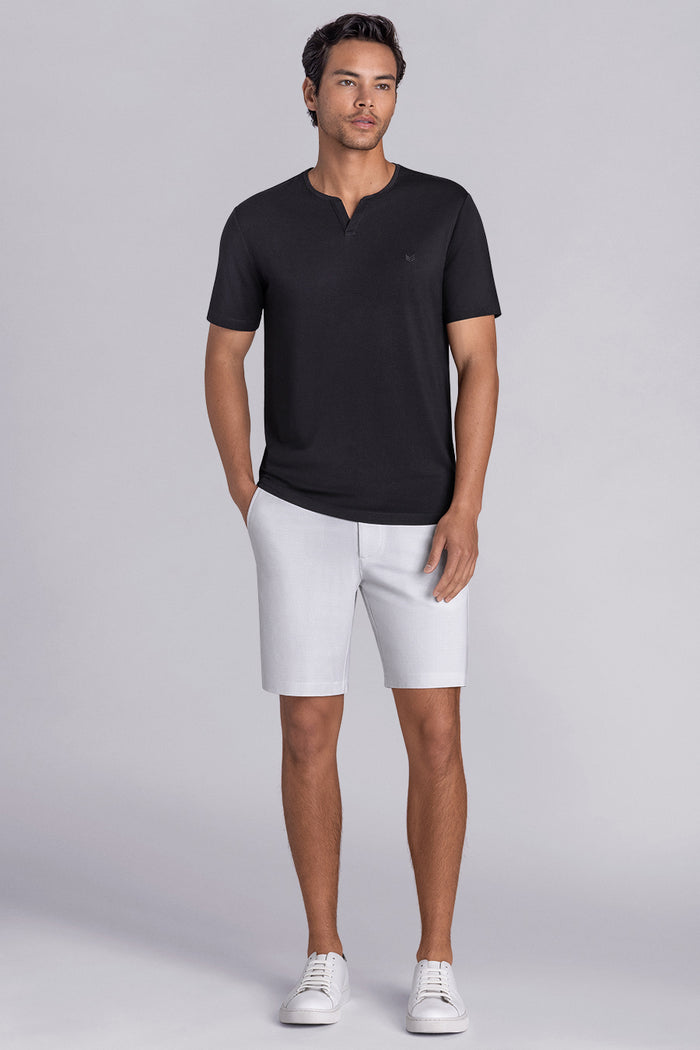 Model wear Infallible in Black short sleeve shirt, styled white shorts