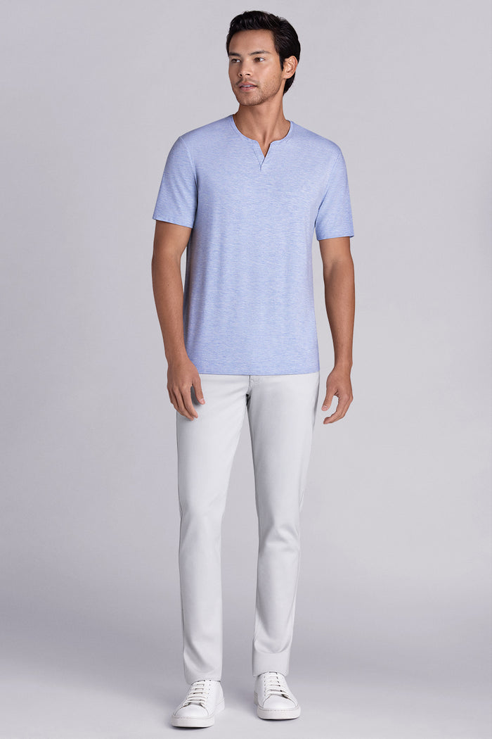 Model wear Infallible in Sky Blue Heather short sleeve shirt, styled white pants