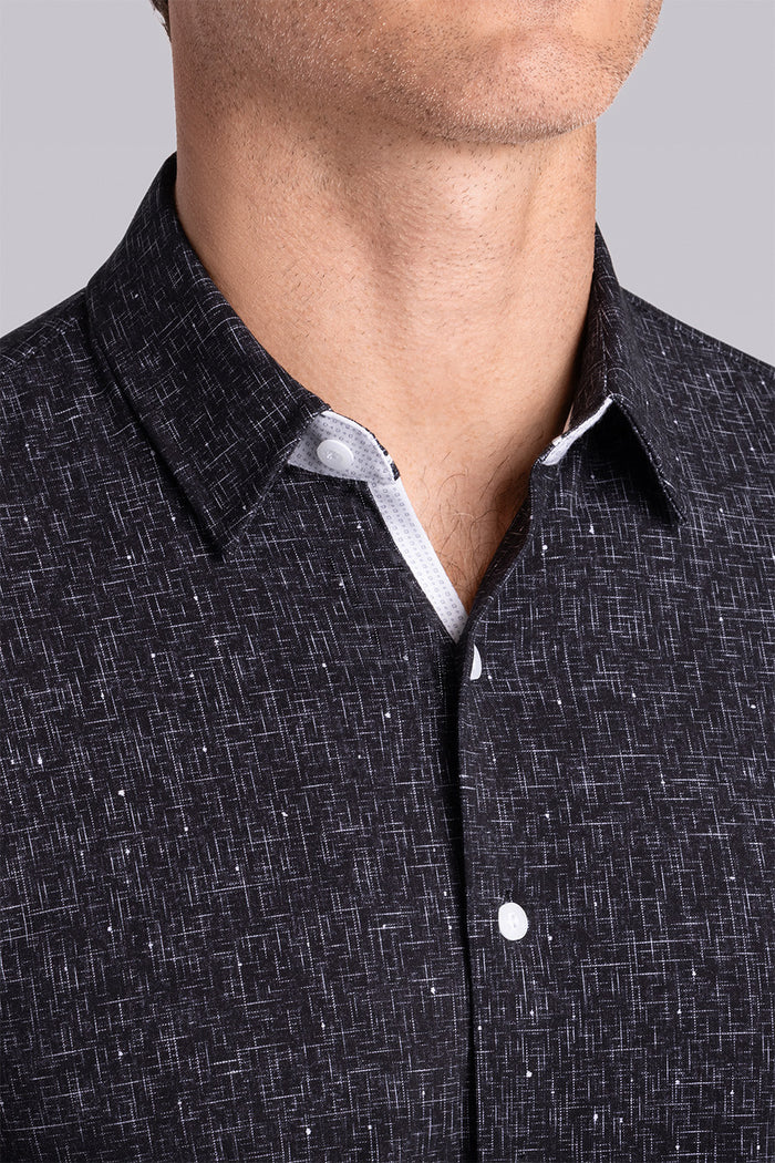 Model wear Integrity Black Icy Cotton® long sleeve classic collar shirt, styled with white pants.