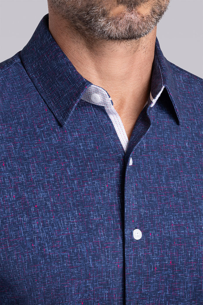 Model wear Integrity Navy Icy Cotton® long sleeve classic collar shirt, styled with white pants.