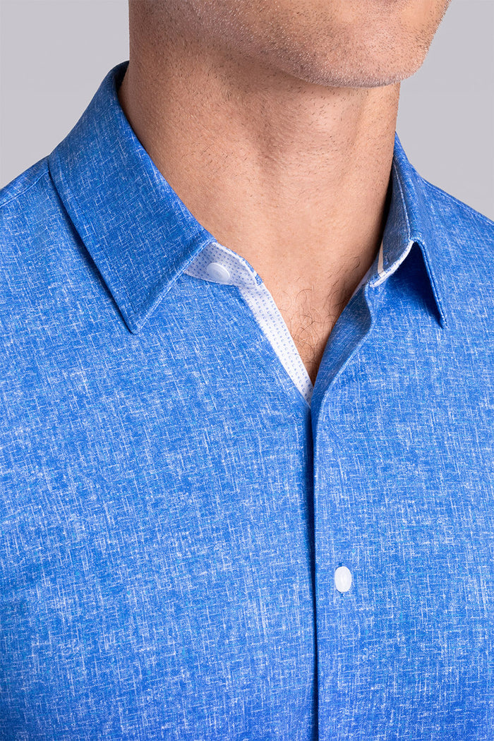 Model wear Integrity Ocean Blue Icy Cotton® long sleeve classic collar shirt, styled with white pants.