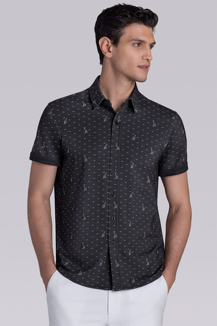 Model wear Intrepid Black short sleeve print shirt, styled with white shorts.
