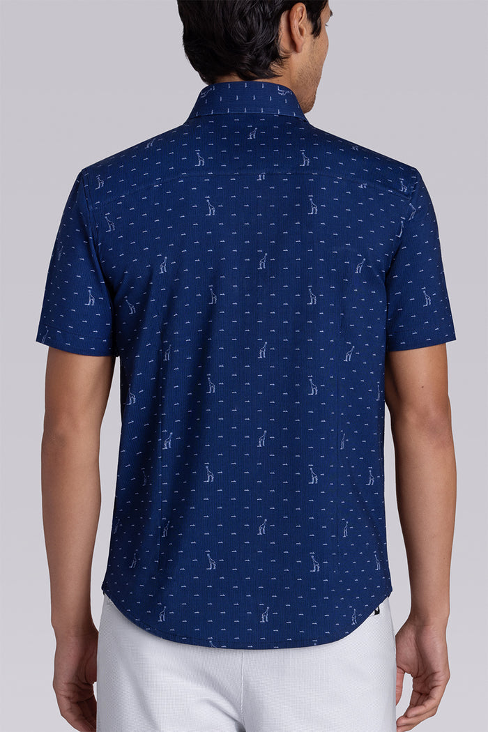 Model wear Intrepid Dark Navy short sleeve print shirt, styled with white shorts.