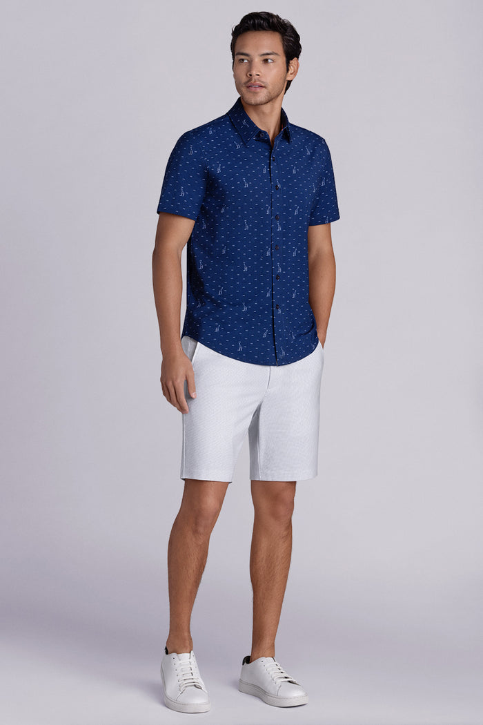 Model wear Intrepid Dark Navy short sleeve print shirt, styled with white shorts.
