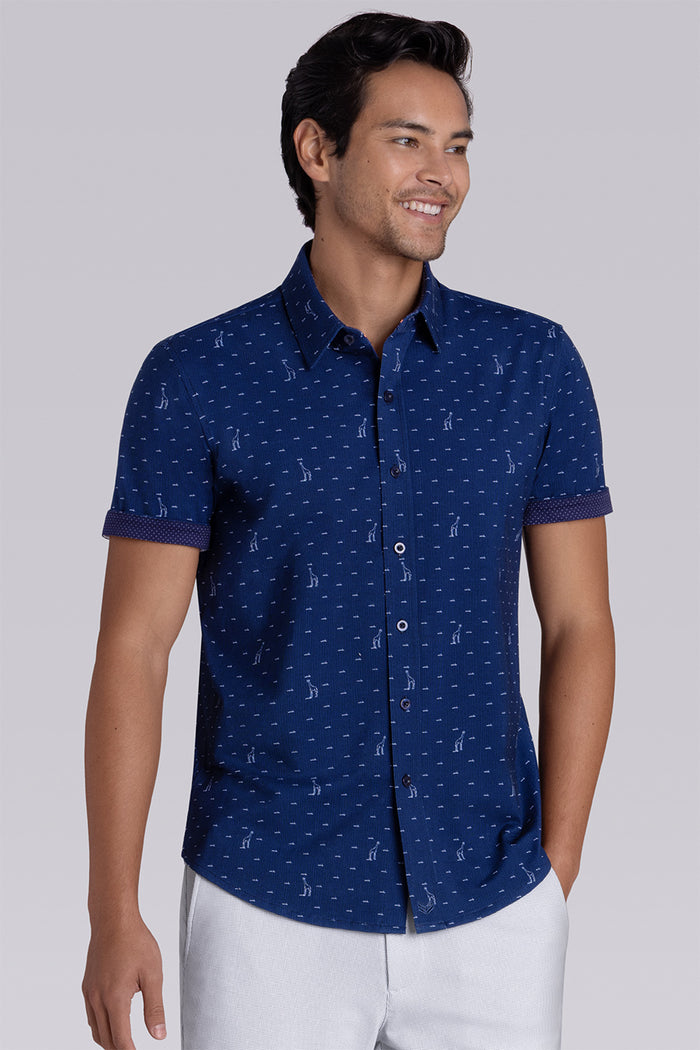 Model wear Intrepid Dark Navy short sleeve print shirt, styled with white shorts.