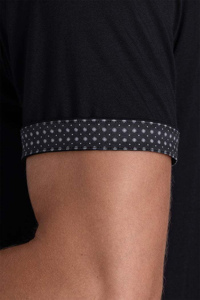 Model wear Intrigue Black Icy Bamboo® short sleeve collar shirt, styled with white pants.