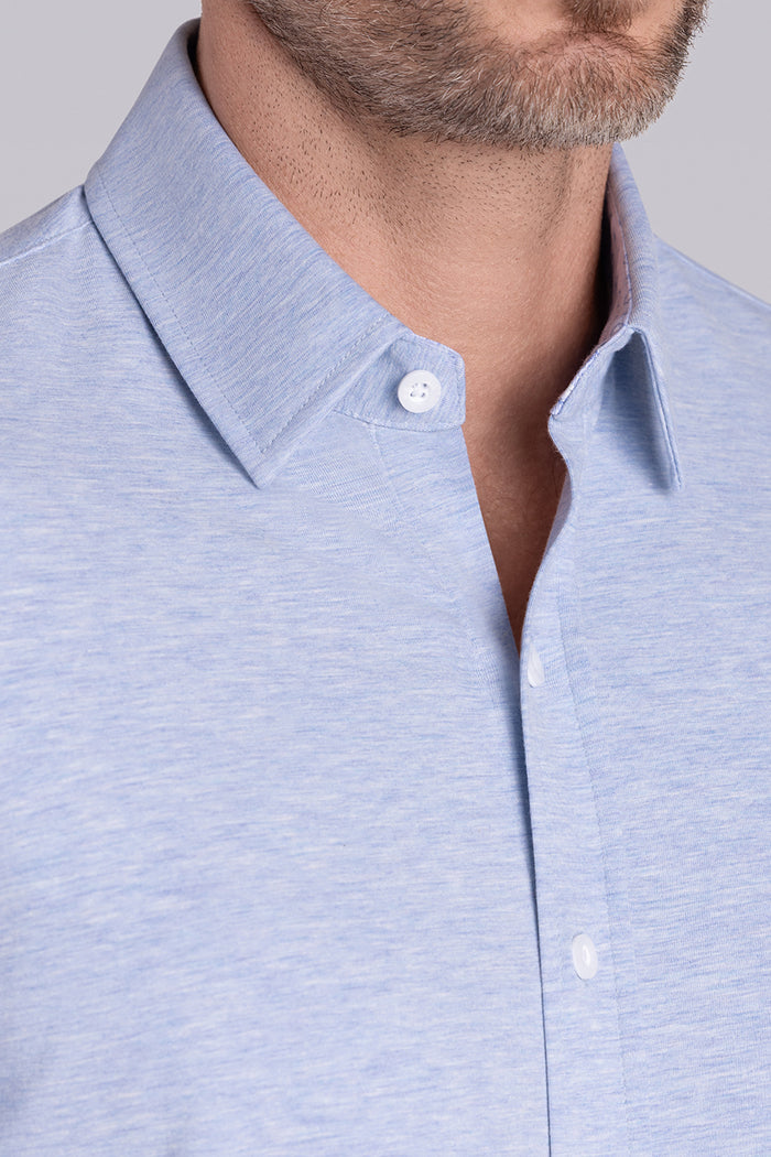 Model wearing the Invigorate Icy Blue Heather long sleeve dress shirt, styled with fitted black dress slacks.