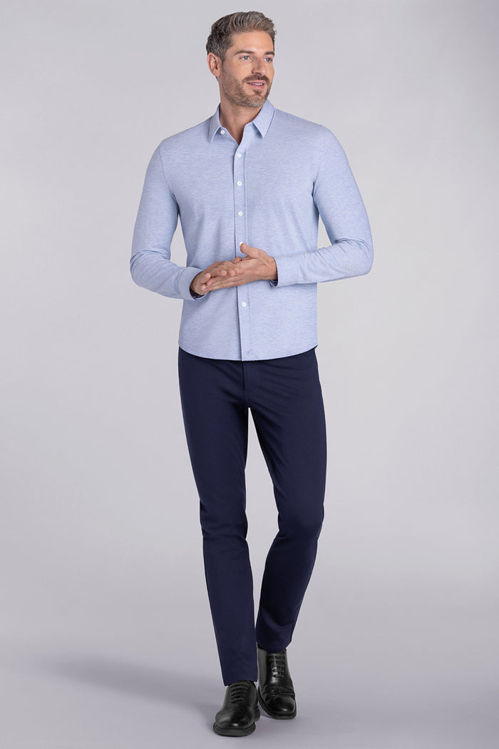 Model wearing the Invigorate Icy Blue Heather long sleeve dress shirt, styled with fitted black dress slacks.