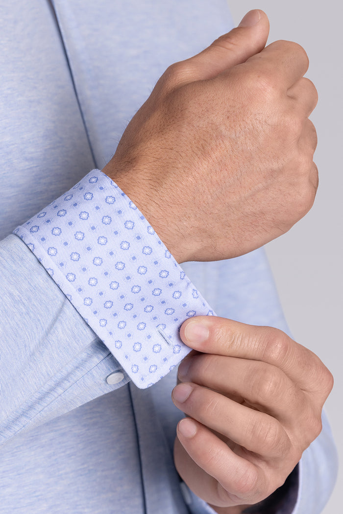 Model wearing the Invigorate Icy Blue Heather long sleeve dress shirt, styled with fitted black dress slacks.