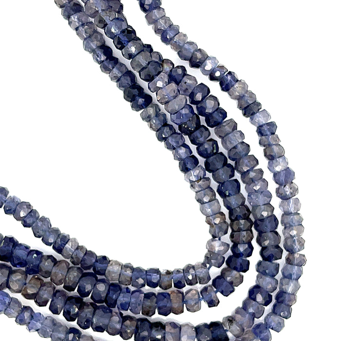 6mm faceted roundel Natural iolite gemstone strand in deep blue for third eye chakra activation and intuition on a white background, front over view.