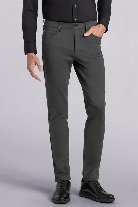Model wearing Kinetic Dark Charcoal dress slacks pants, styled with comfortable black shirt