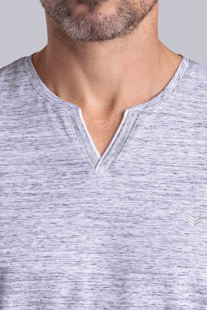 Model wear Lucid Bone White Heather Icy Cotton® short sleeve v-notch shirt, styled with white shorts