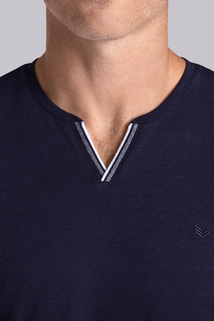 Model wear Lucid Navy Icy Cotton® short sleeve v-notch shirt, styled with white shorts