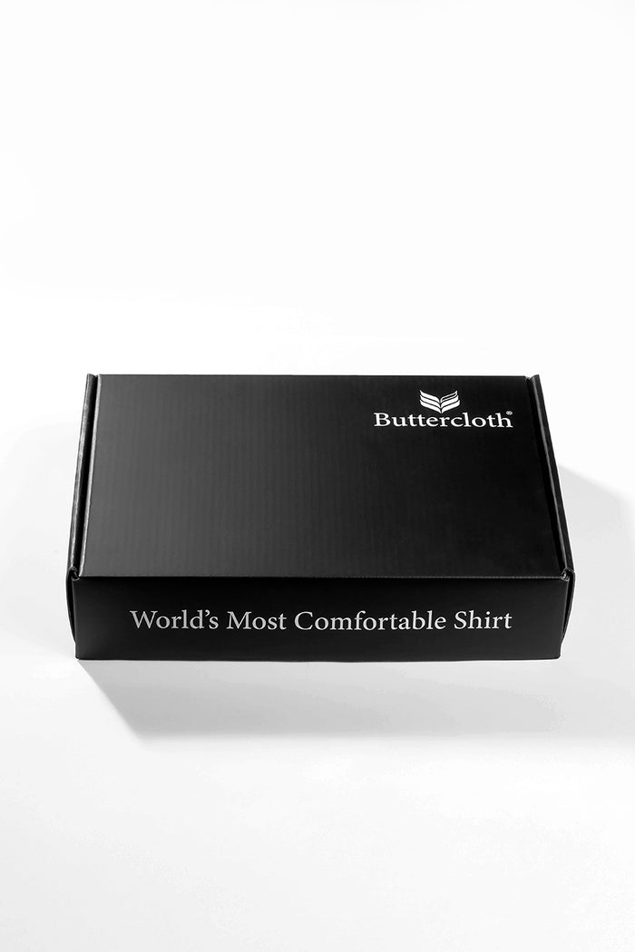 A black luxurious gift box with a black ribbon tied around it.