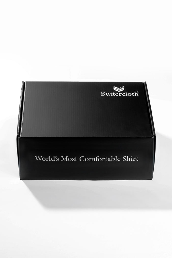 A black luxurious gift box with a black ribbon tied around it.