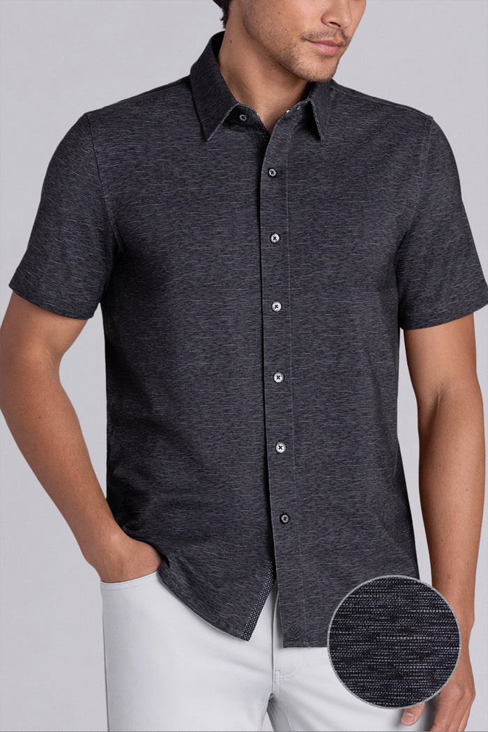 Model wearing Magnetic Black short sleeve collar shirt, styled with white pants.v