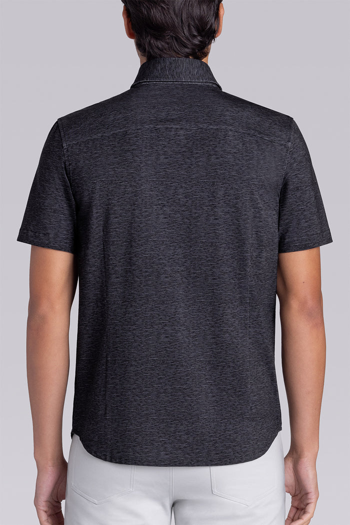 Model wearing Magnetic Black short sleeve collar shirt, styled with white pants.