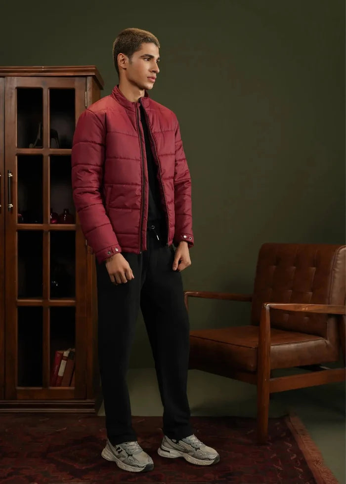 Burgundy men's bubble quilted jacket with zip-up front, side pockets, elastic cuffs