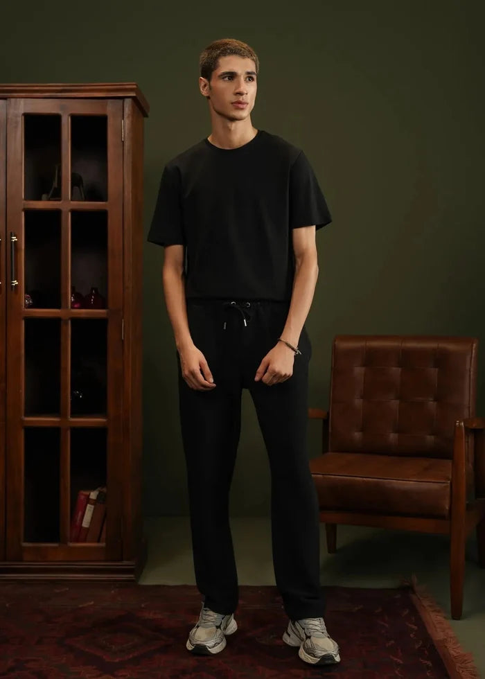 Men's black pull-on winter trousers with drawstring waist and tapered legs
