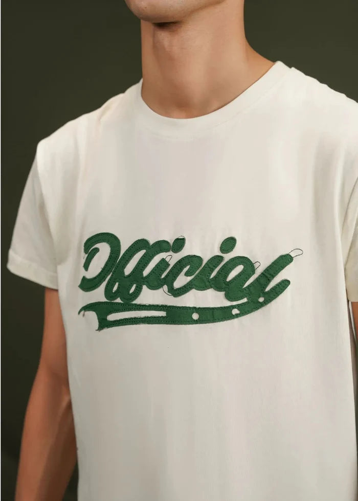 Off-white graphic T-shirt close-up of green logo print on chest.