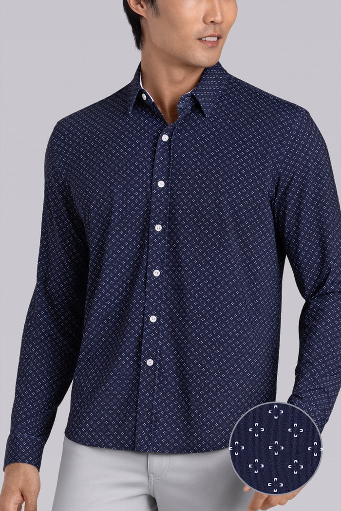 Model wearing Mesmerize Navy long sleeve dress shirt, styled with grey pants.