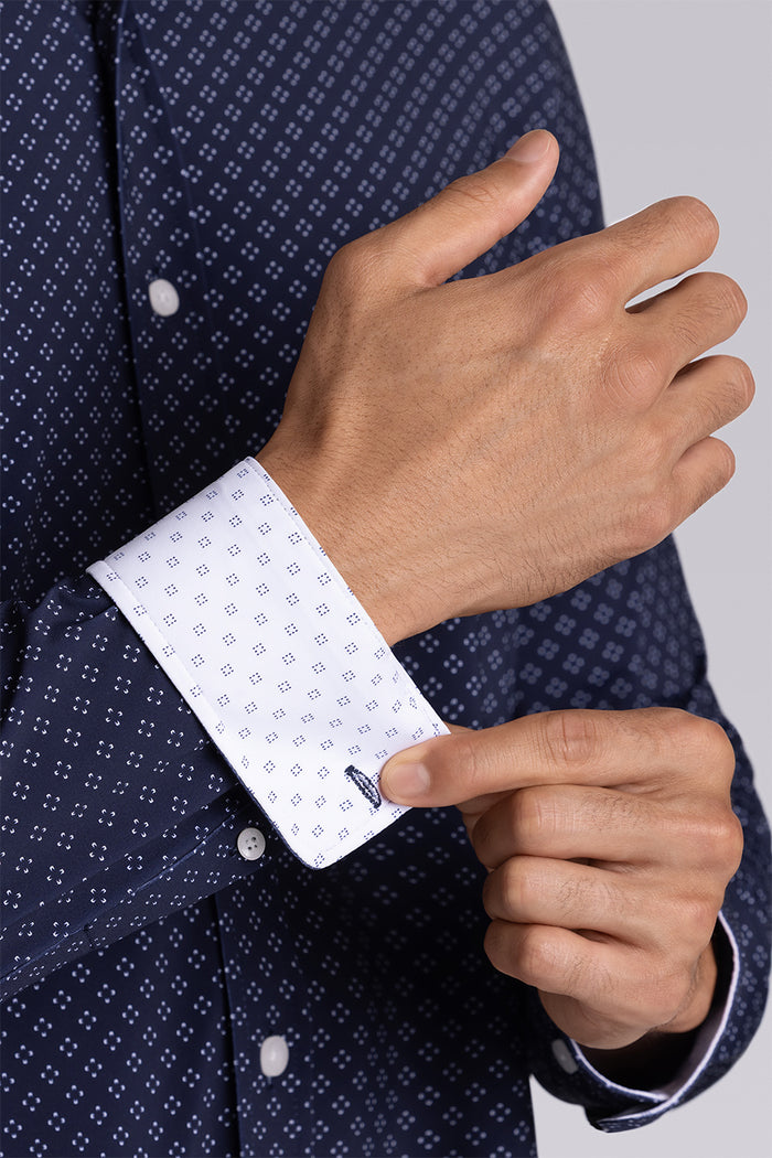 Model wearing Mesmerize Navy long sleeve dress shirt, styled with grey pants.