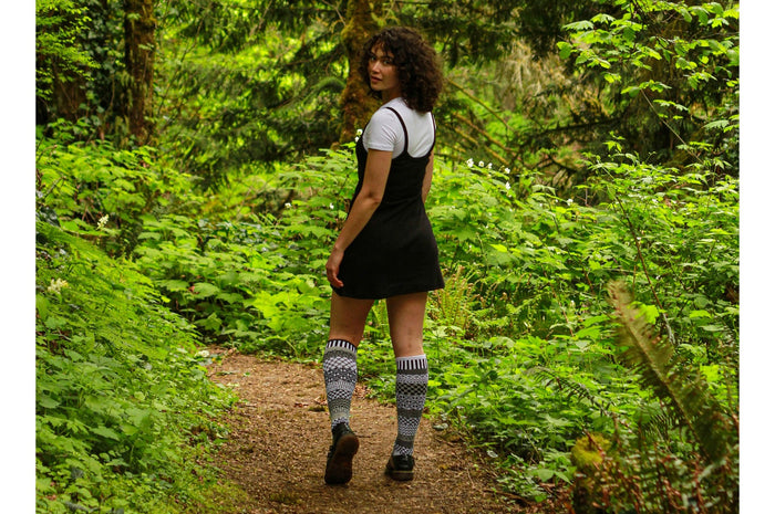 Solmate Midnight knee socks worn on a woodland walking trail