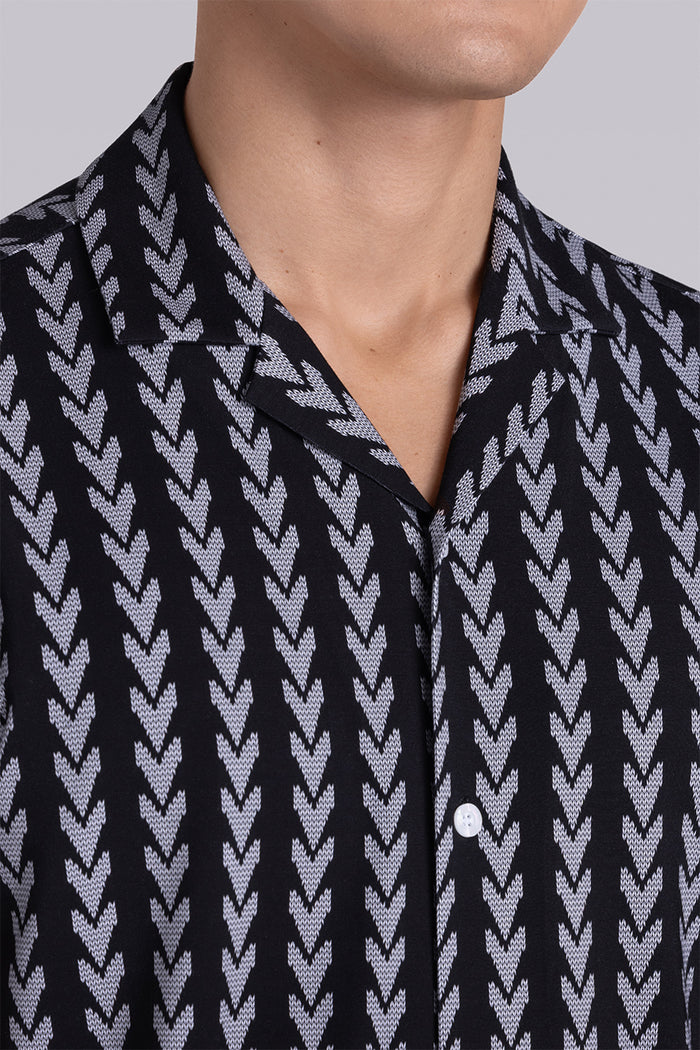 Model wear Mirage Black Icy Bamboo® short sleeve camp shirt, styled with white shorts