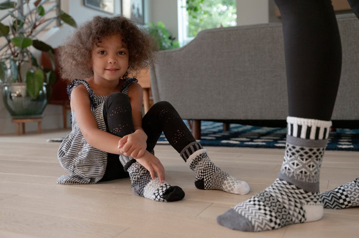 Child wearing Moonlight Kids Socks while sitting on the floor