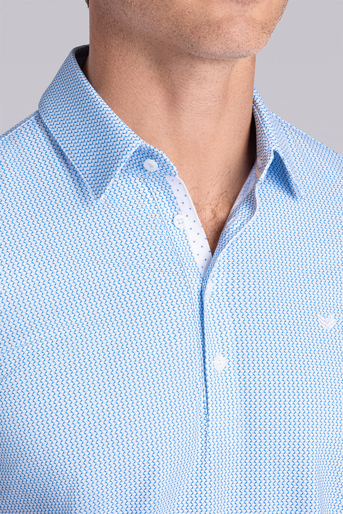 Model wearing Mosaic Light Blue Icy Cotton® short sleeve micro geo print polo, styled with white shorts.