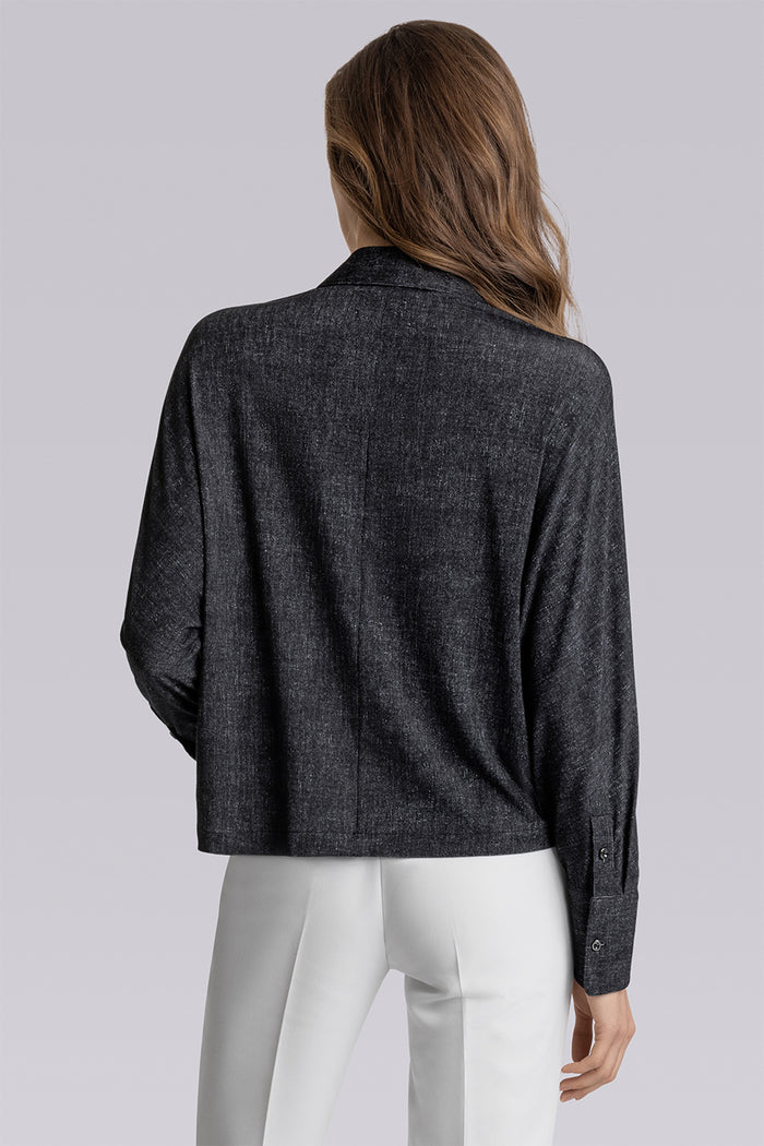 Model Motif Black Charcoal long sleeve button up blouse, styled with white pants
