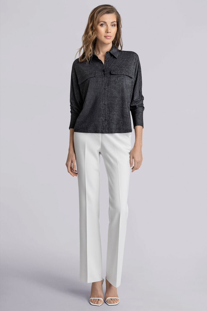 Model Motif Black Charcoal long sleeve button up blouse, styled with white pants