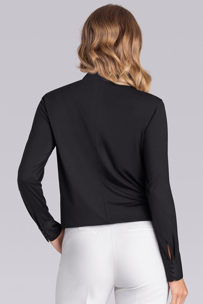 Model wearing Muse Black Icy Bamboo® keyhole mock neck long sleeve blouse, styled with white pants