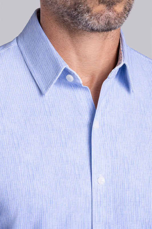Model wearing Ocean Drive Icy Blue short sleeve button-up shirt, styled with white shorts
