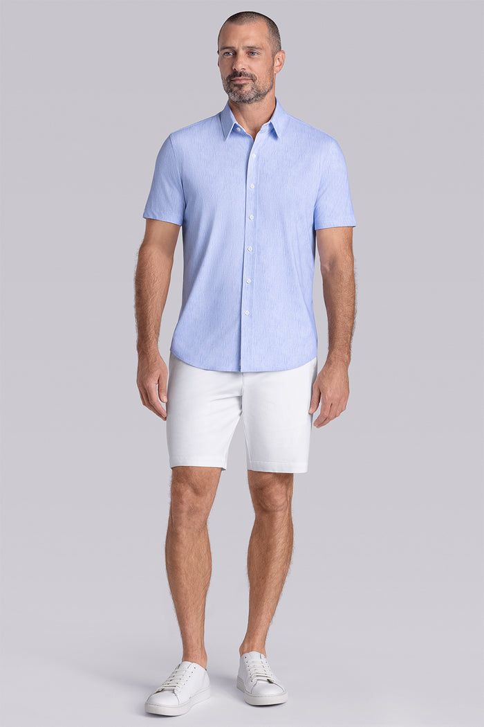 Model wearing Ocean Drive Icy Blue short sleeve button-up shirt, styled with white shorts